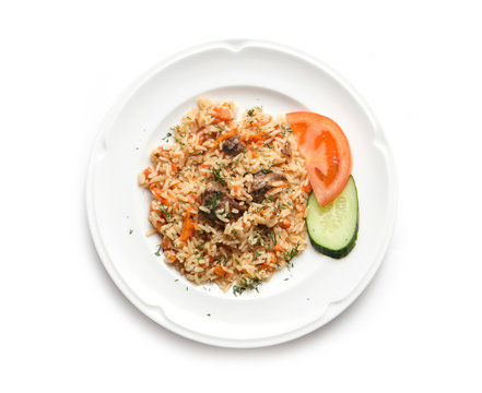 Traditional oriental pilaf with mutton, uzbek pilaf on a white plate on white background, top view