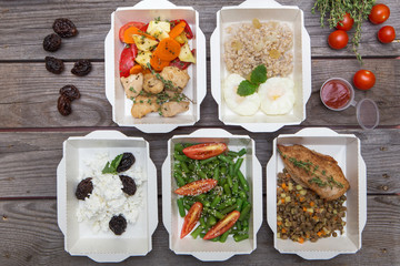 Clean healthy oil-free low fat ready to eat food in takeaway meal box sets on wood background top view with copy space