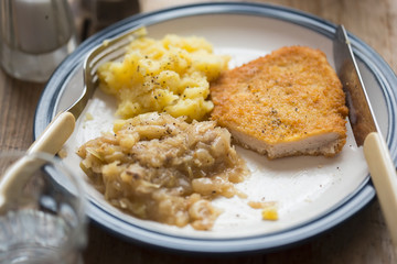 Breaded chicken breast with mashed potatoes and cabbage 