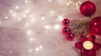 verträumte Weihnachtdekoration mit Kerze,  roten Kugeln und rotem Stern