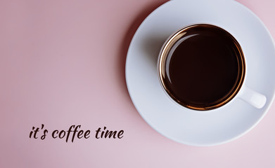 Cup of espresso coffee with text love coffee on a saucer on a pale pink background. Flatlay. View from above.