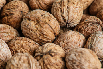 walnuts, unpeeled greek nuts, harvest of walnuts, walnuts closeup, background with walnuts,organic delicious nuts. healthy snack.