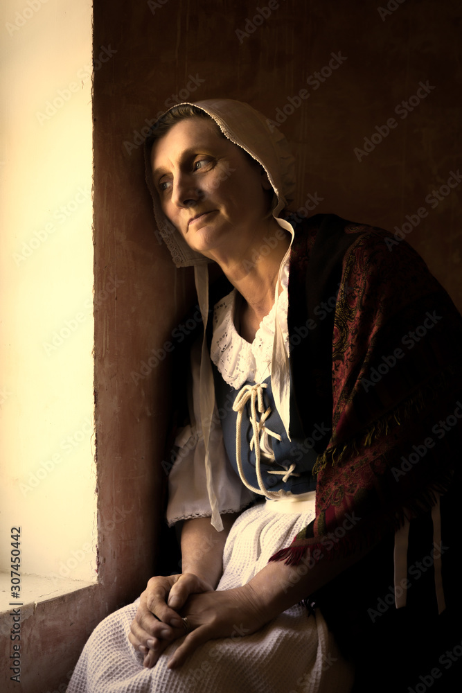 Wall mural woman sitting at window in old master style