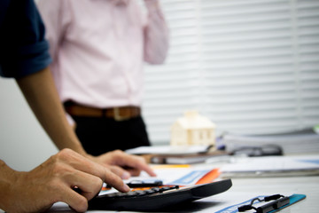 businessman working use calculator for analyze in office for discussing documents and ideas , with soft focus, vintage tone