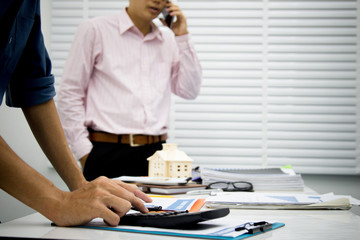 businessman working use calculator for analyze in office for discussing documents and ideas , with soft focus, vintage tone