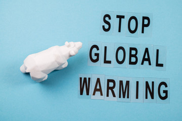 Toy polar bear struggling showing impact on climate of the polar bear due to global warming