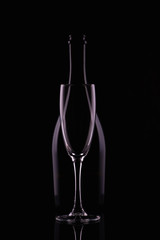 Abstract bottle champagne and glass shapes reflection on a black background