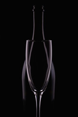 Abstract bottle champagne and glass shapes reflection on a black background