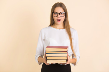 beautiful young woman in glasses with books in her hands