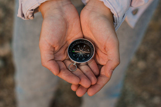 Compass on a woman hands. Adventure concept and travel