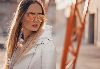 Beautiful blonde woman in yellow sunglasses in outdoor