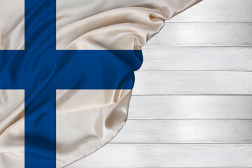 horizontal color national flag of modern state of Finland, beautiful silk, white wood background, concept of tourism, economy, politics, emigration, independence day, copy space, template