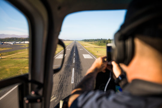 Passenger photographs landing on airport  airstrip