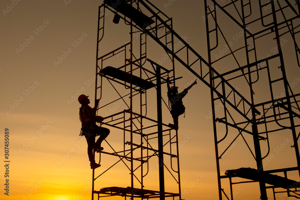 Poster silhouette construction worker climbing scaffolding in order to go up to check the work site