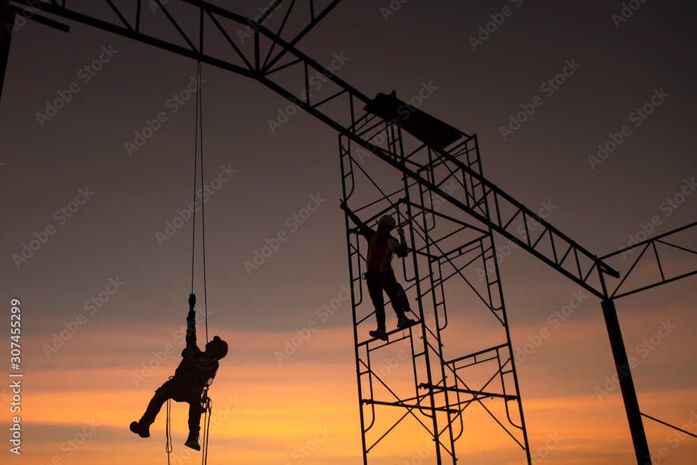 Poster silhouette construction worker climbing scaffolding in order to go up to check the work site