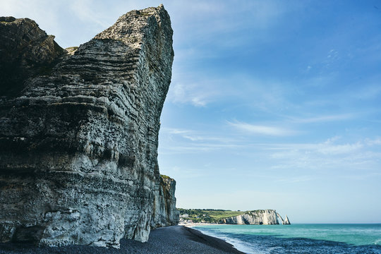 Huge rock in the blue sky in the Normandy seashore