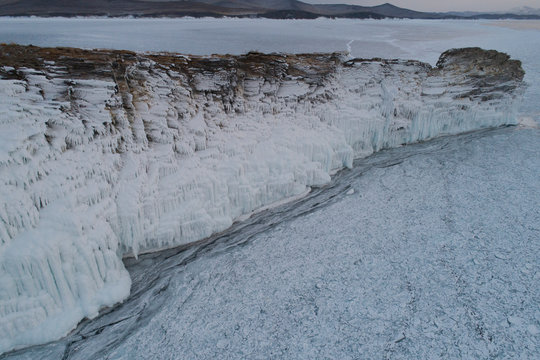 34/5000 rocky cliff surrounded by ice