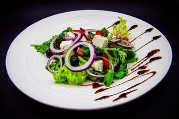 Greek salad on black background