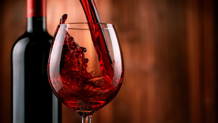 Detail of pouring red wine into glass
