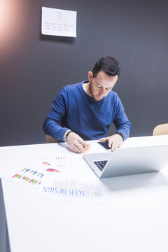 Bearded Man working on laptop in office