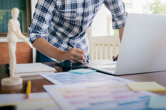 Graphic design and color swatches and pens on a desk.