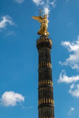 Berlin victory column in front of a blue sky with some clouds