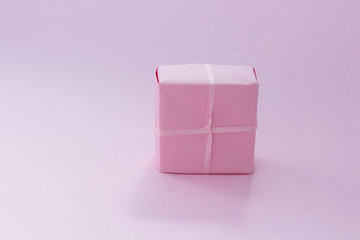 Lay out made of present box in pink pastel color with copy space Christmas gift New Year