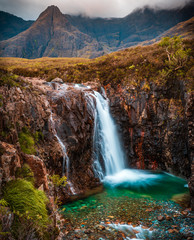 Fairy Pools waterfall in the Isle of Skye, Scotland next to Glen brittle mountain in the Scottish Highlands. Natural magical place with vivid colors and crystal clear blue pools on the river.