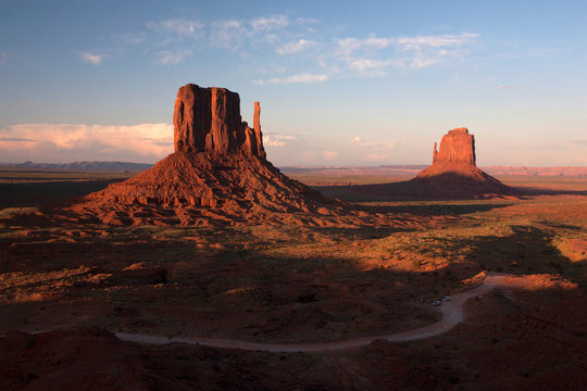Sunset light hits the iconic rock formations in Monument Valley, AZ