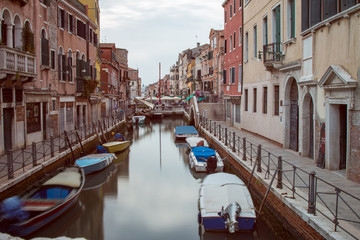 Long exposure of a Venice canal with several boats parked