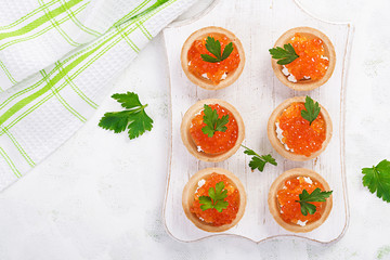 Tartlets with salmon red caviar and feta cheese. Sandwich for lunch. Delicious food. Top view, overhead