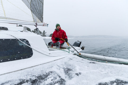 Man yachting on snowy day