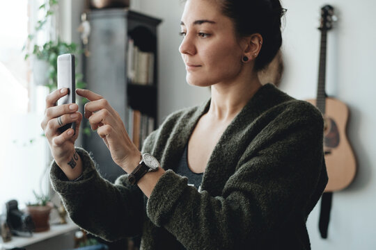 Woman using smartphone at home