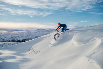 Man cycling in snow