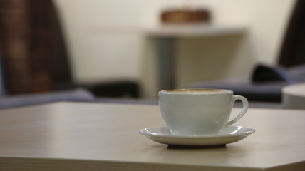 Fototapeta na wymiar cup of coffee on beige table