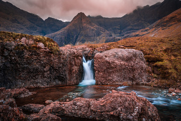 Fairy Pools waterfall in the Isle of Skye, Scotland located next to Glen brittle in the Scottish Highlands. Natural magical place with vivid colors and crystal clear blue pools on the river.