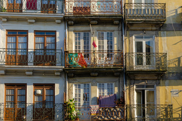 View on the old facade with balcony and the Portugal flag