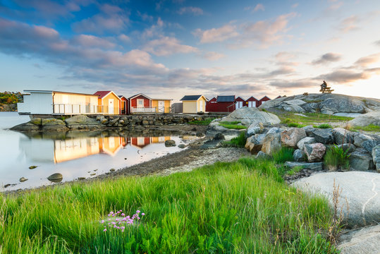 Boat huts at rocky coast