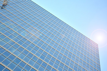 Fototapeta na wymiar Modern office building detail, glass surface with sunlight. Business background. 