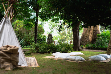 Small tipi indian tent with pillows in the woods