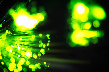 Colorful technological background of optical fibre with bokeh. Abstract IT background. Fiber optic ends closeup. Slightly blurred.