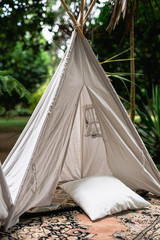 Small tipi indian tent with pillows in the woods © Ivan Castro