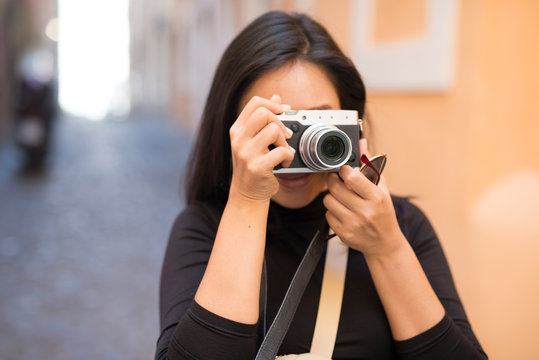 Young woman photographing