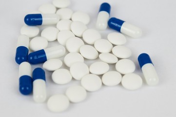 Blue capsules and white pills