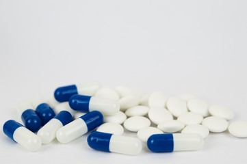 Blue capsules and white pills