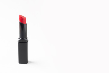 Red lipstick in a black tube isolated on a white background. Beauty and lip care, cosmetics. Copy space