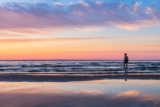 Silhouette of person on beach at sunset