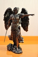 bronze sculpture of Archangel Michael with wings and sword