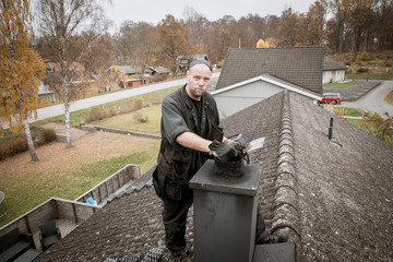 Chimney sweep on roof