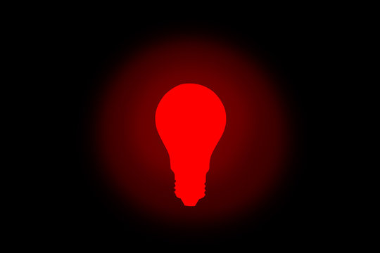 Red lamp bulb on the black background. New idea concept.